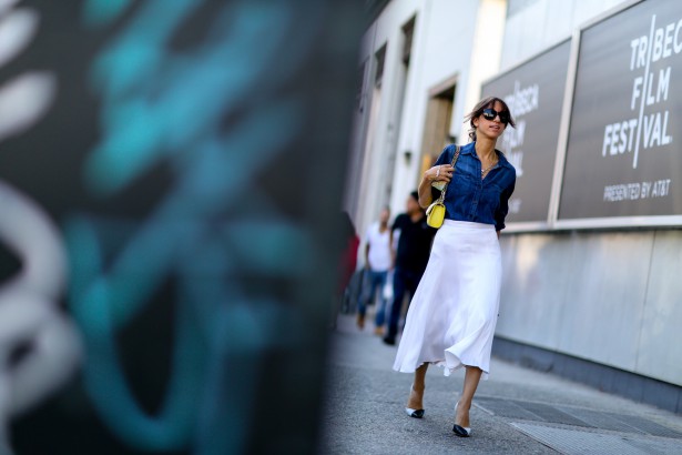 In denim shirt and flowing skirt