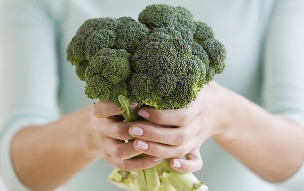 Woman holding broccoli